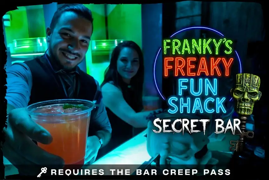 Bartender presenting neon drink at Franky’s Freaky Fun Shack secret bar, Hush Haunted Attraction, Detroit haunted house.