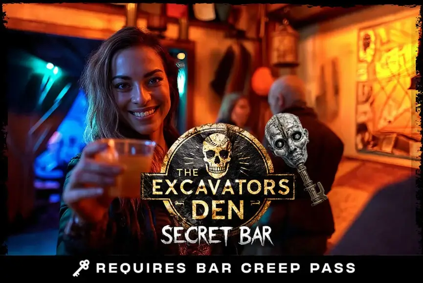 Guest raising a cocktail in The Excavator’s Den secret bar, available with Bar Creep Pass at Hush Haunted Attraction, MI.