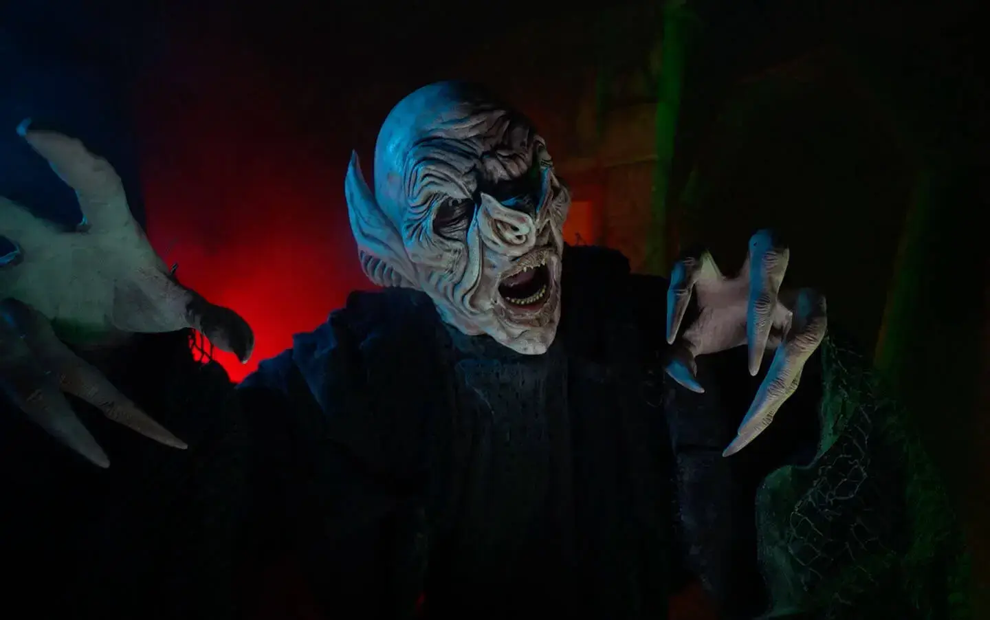 Masked vampire actor inside Detroit haunted attraction